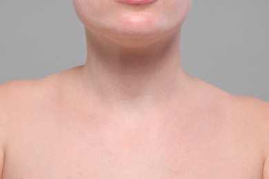 Photo of Closeup view of woman with normal skin on grey background