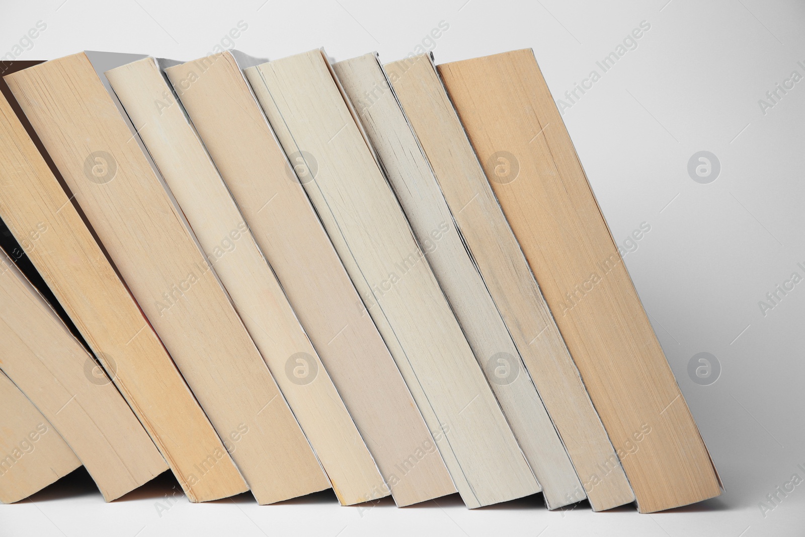 Photo of Collection of different books on light background