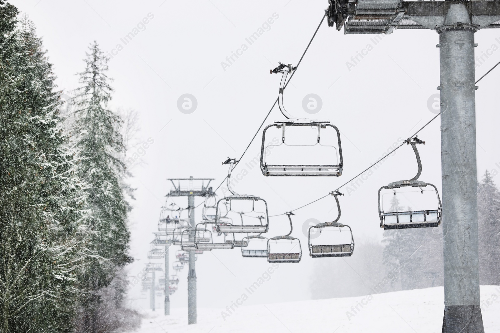 Photo of Ski lift at mountain resort. Winter vacation