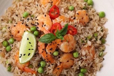Photo of Tasty rice with shrimps and vegetables in bowl, top view