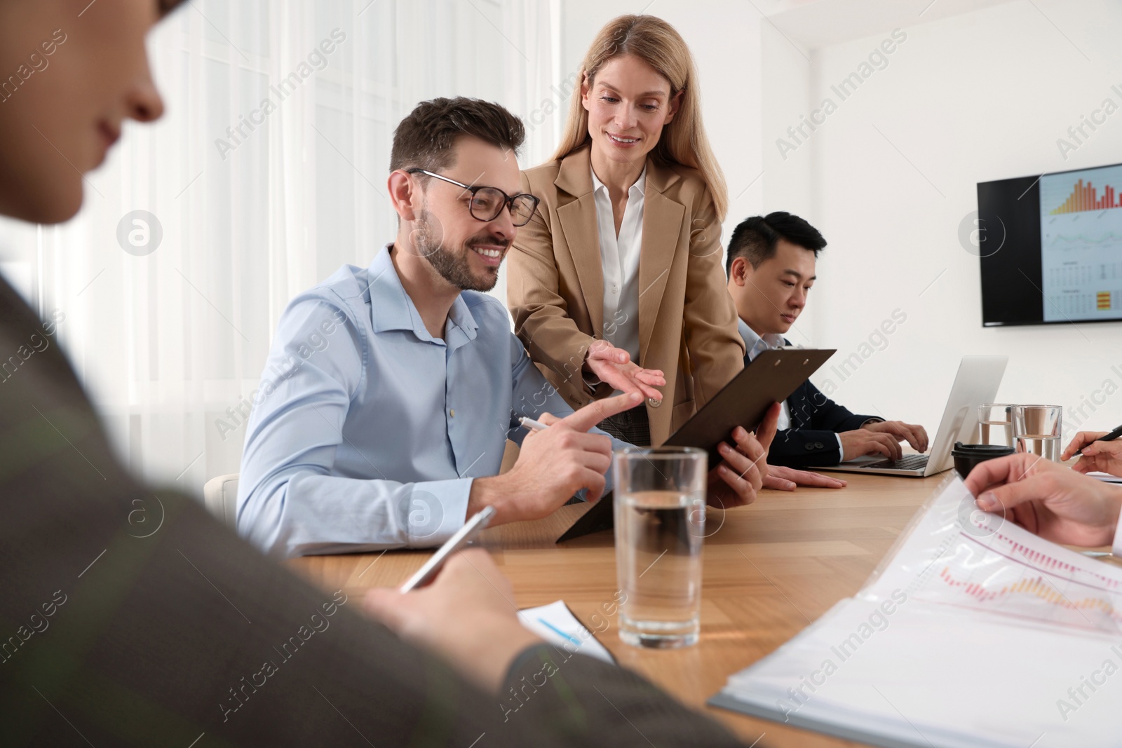 Photo of Businesswoman having meeting with her employees in office