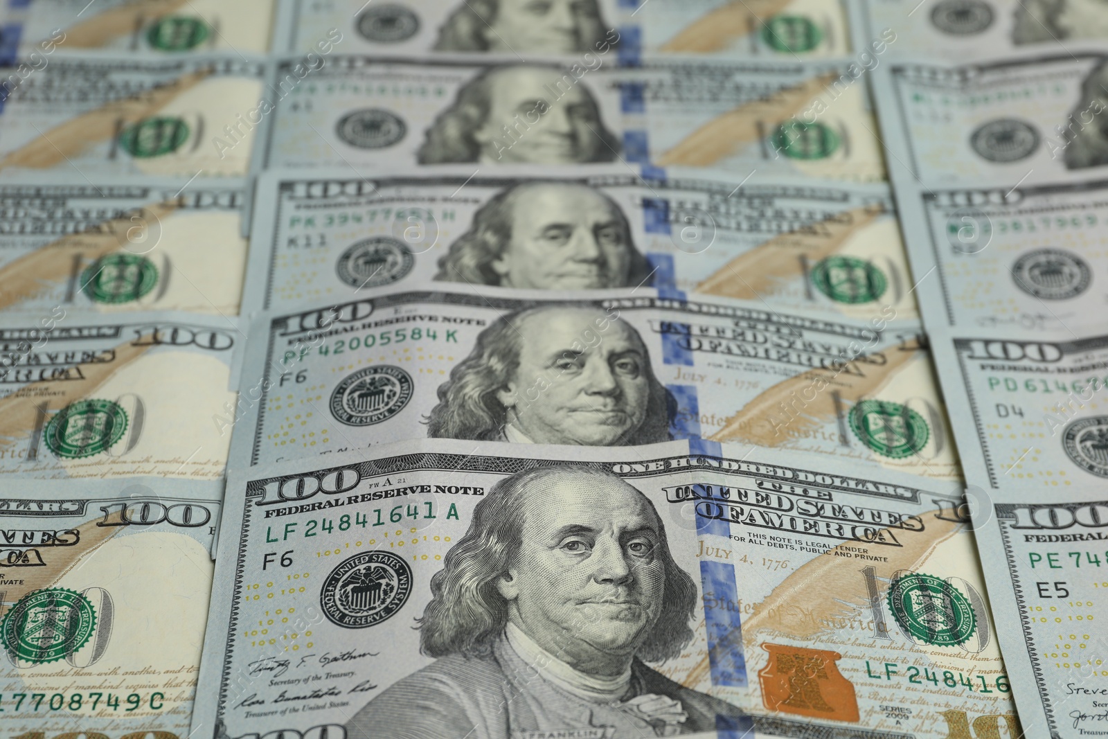 Photo of Money exchange. Dollar banknotes as background, closeup