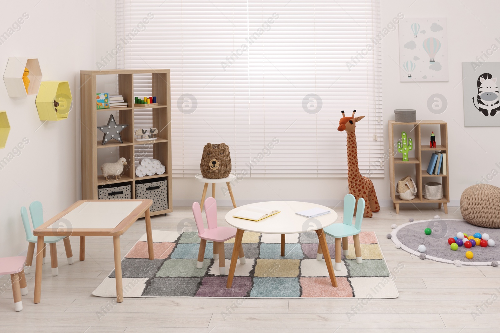 Photo of Stylish kindergarten interior with toys and modern furniture