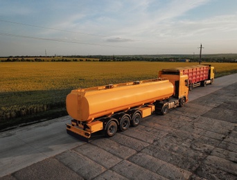 Modern bright trucks parked on country road