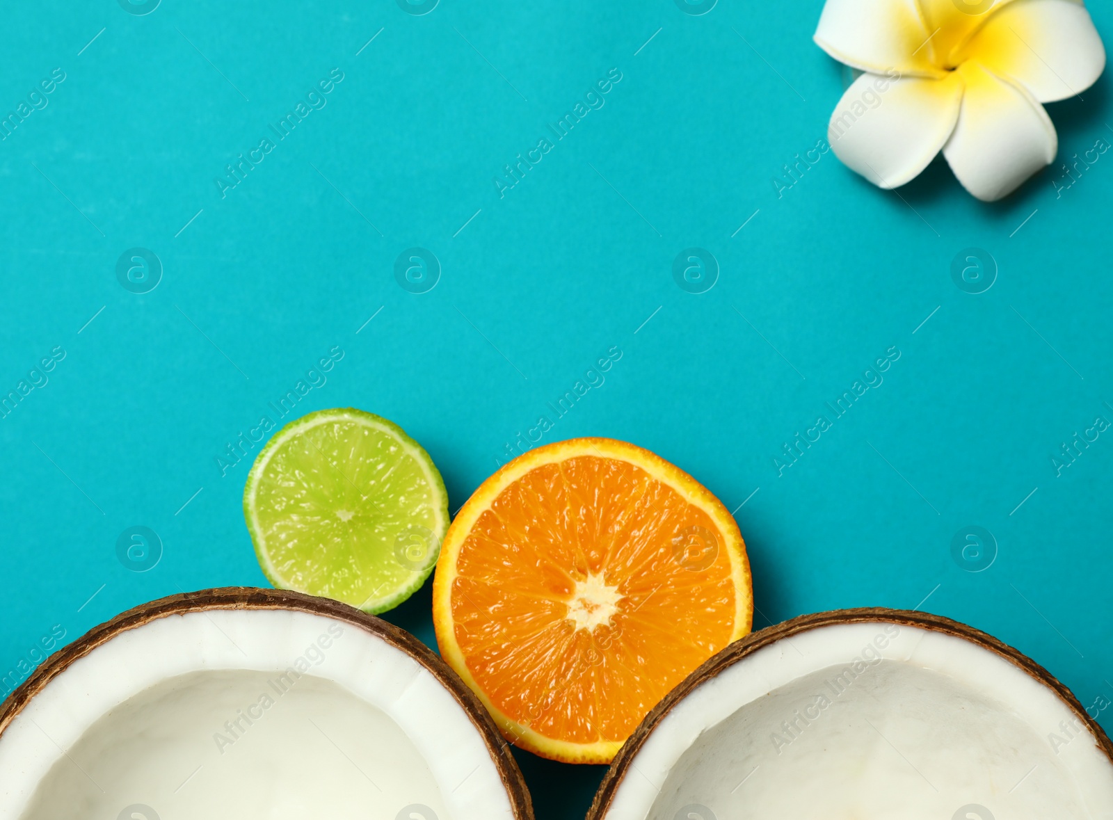 Photo of Flat lay composition with fresh coconut halves on blue background. Space for text