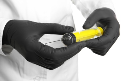 Photo of Doctor in medical gloves holding empty syringe, closeup