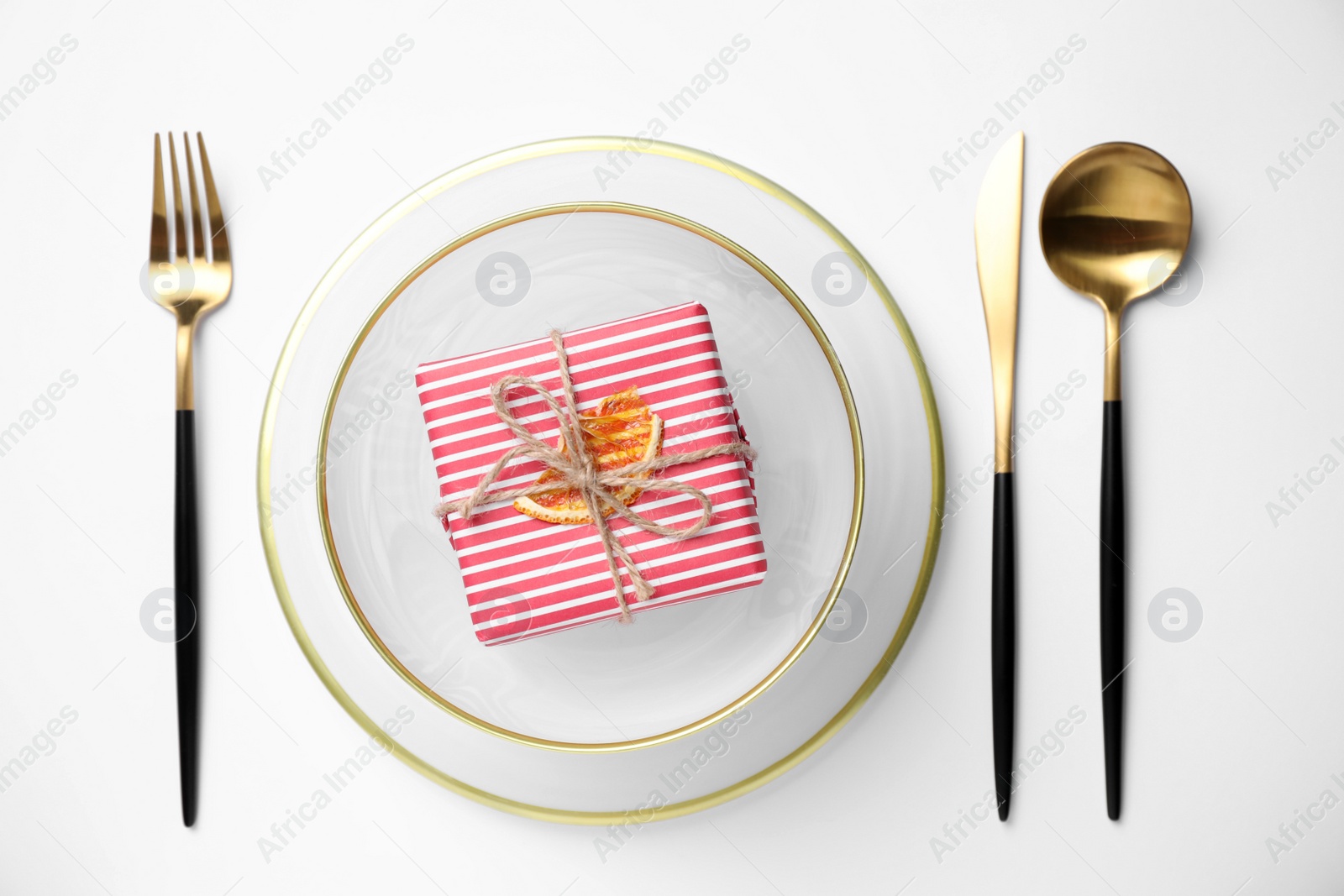 Photo of Stylish table setting and gift box on white background, top view