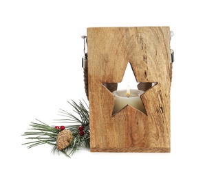 Wooden Christmas lantern with burning candle near fir branch and pine cone on white background