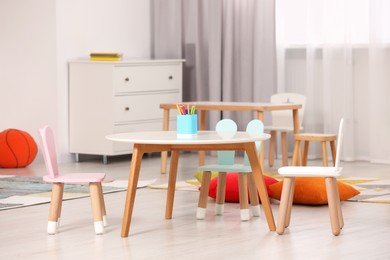 Photo of Child`s playroom with comfortable furniture. Stylish kindergarten interior