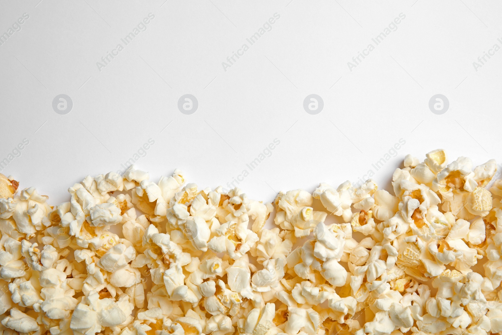 Photo of Delicious fresh popcorn on white background, top view