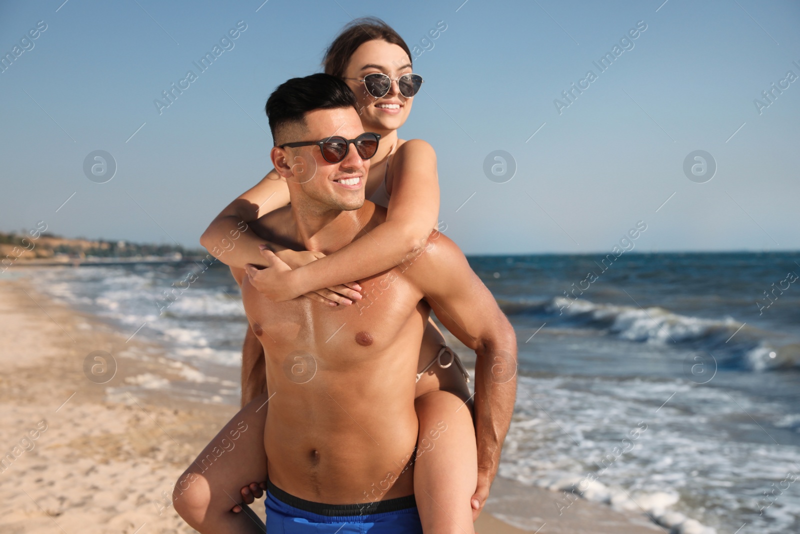 Photo of Lovely couple spending time together on beach