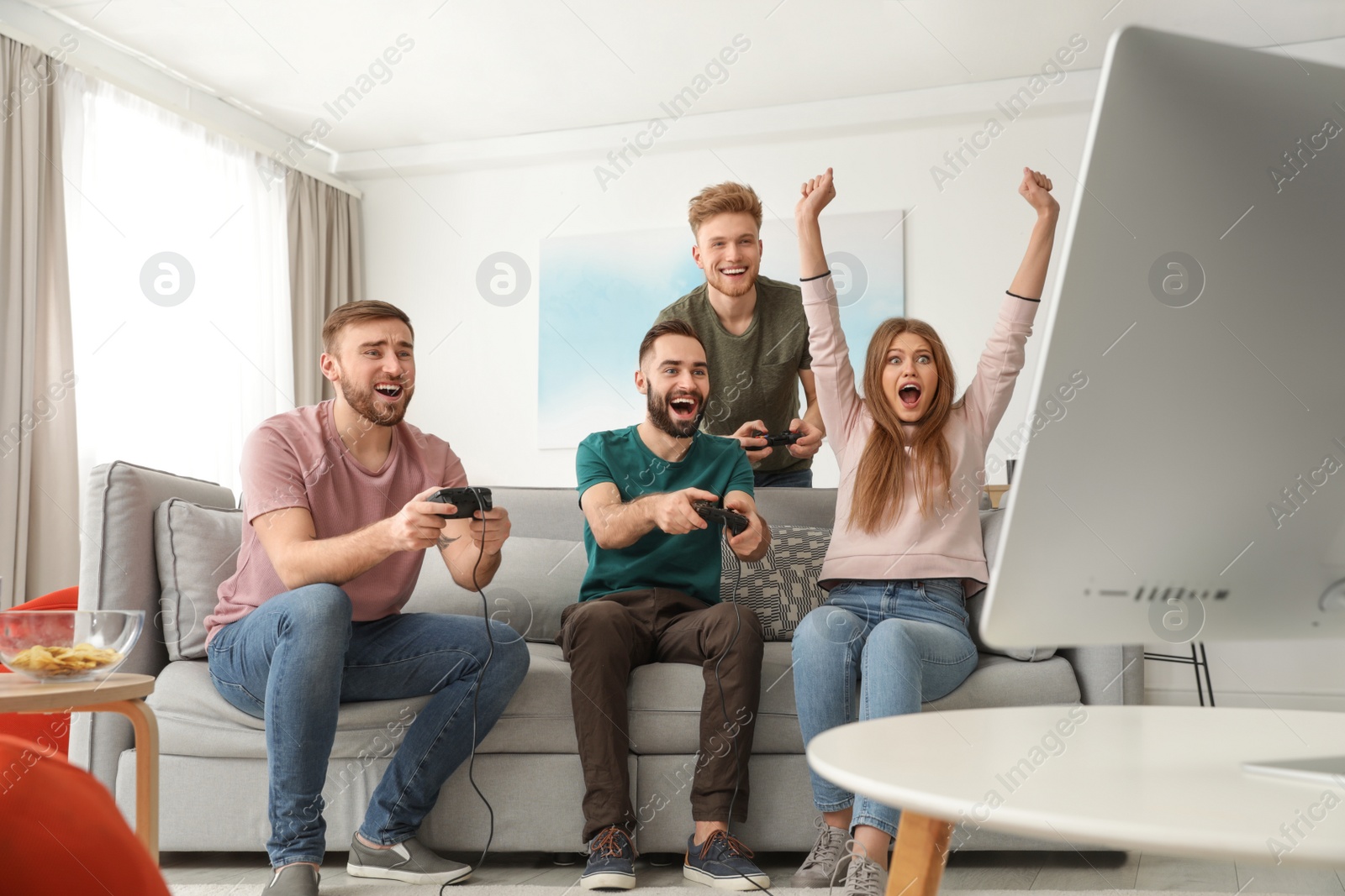 Photo of Emotional friends playing video games at home