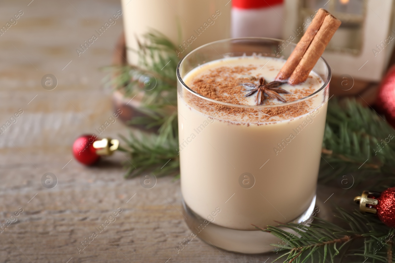 Photo of Delicious Christmas liqueur on wooden table, closeup