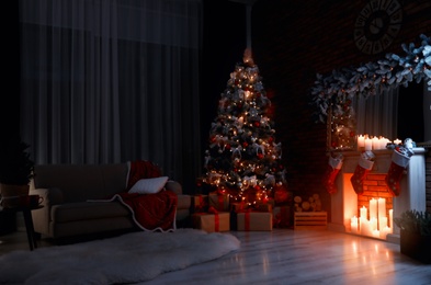 Stylish room interior with beautiful Christmas tree in evening