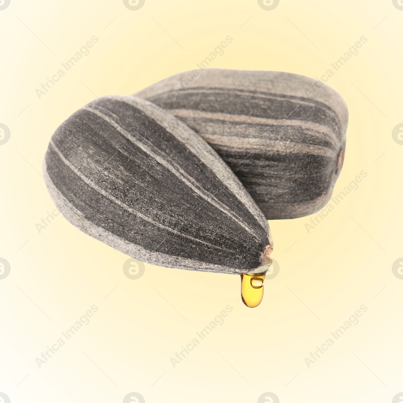 Image of Sunflower seeds in husk with oil on beige gradient background