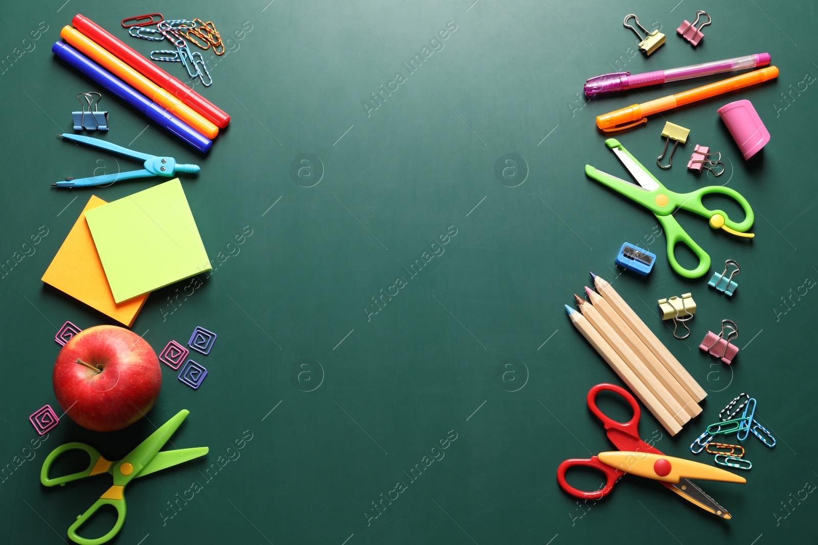 Photo of Flat lay composition with scissors and school supplies on chalkboard. Space for text