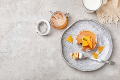 Flat lay composition with tasty pancakes on grey background