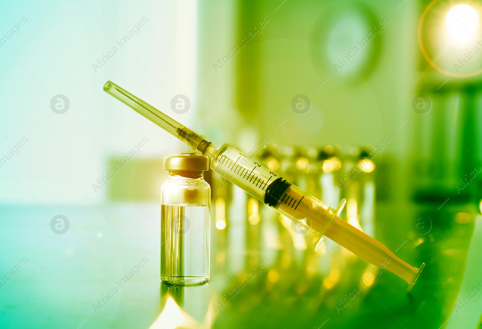 Image of Syringe with vial of medicine on table