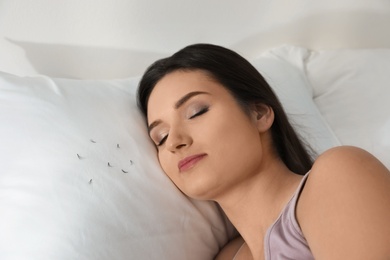Photo of Young woman with eyelash loss problem sleeping in bed. Space for text