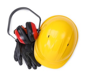 Hard hat, earmuffs and gloves isolated on white, top view. Safety equipment