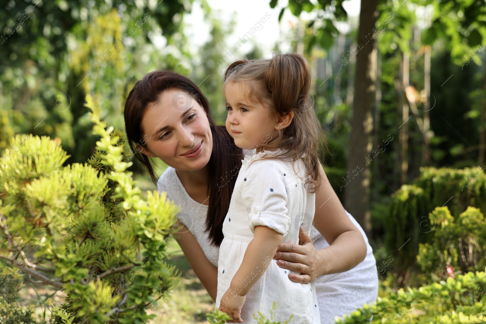 Photo of Mother with her cute daughter spending time together in park