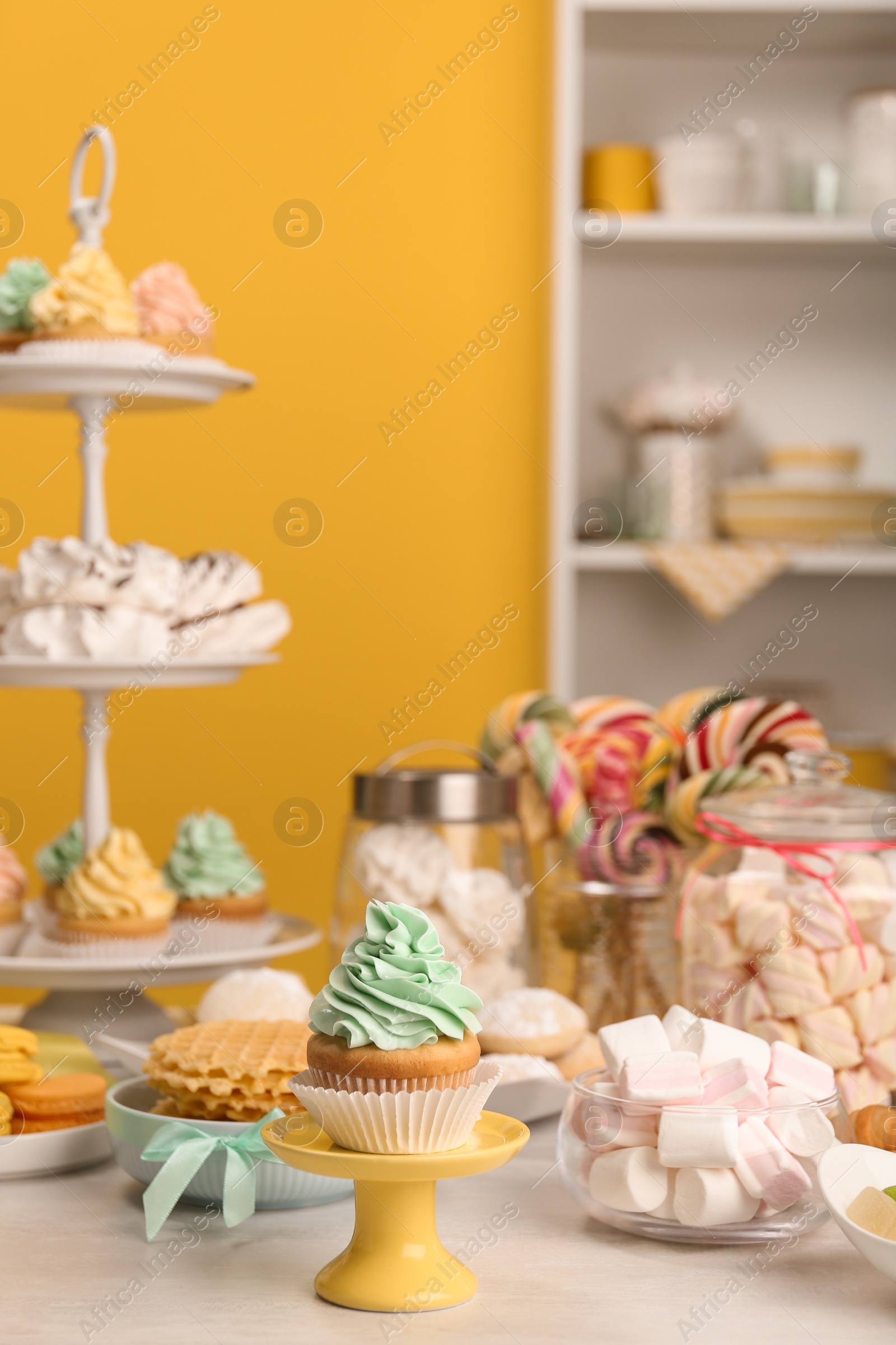 Photo of Table with different sweets in room. Candy bar for party