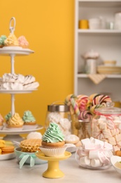 Table with different sweets in room. Candy bar for party