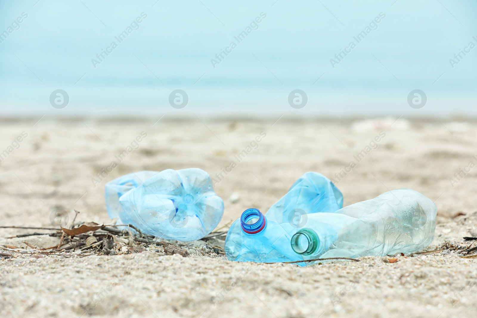 Photo of Used plastic bottles on beach, space for text. Recycling problem