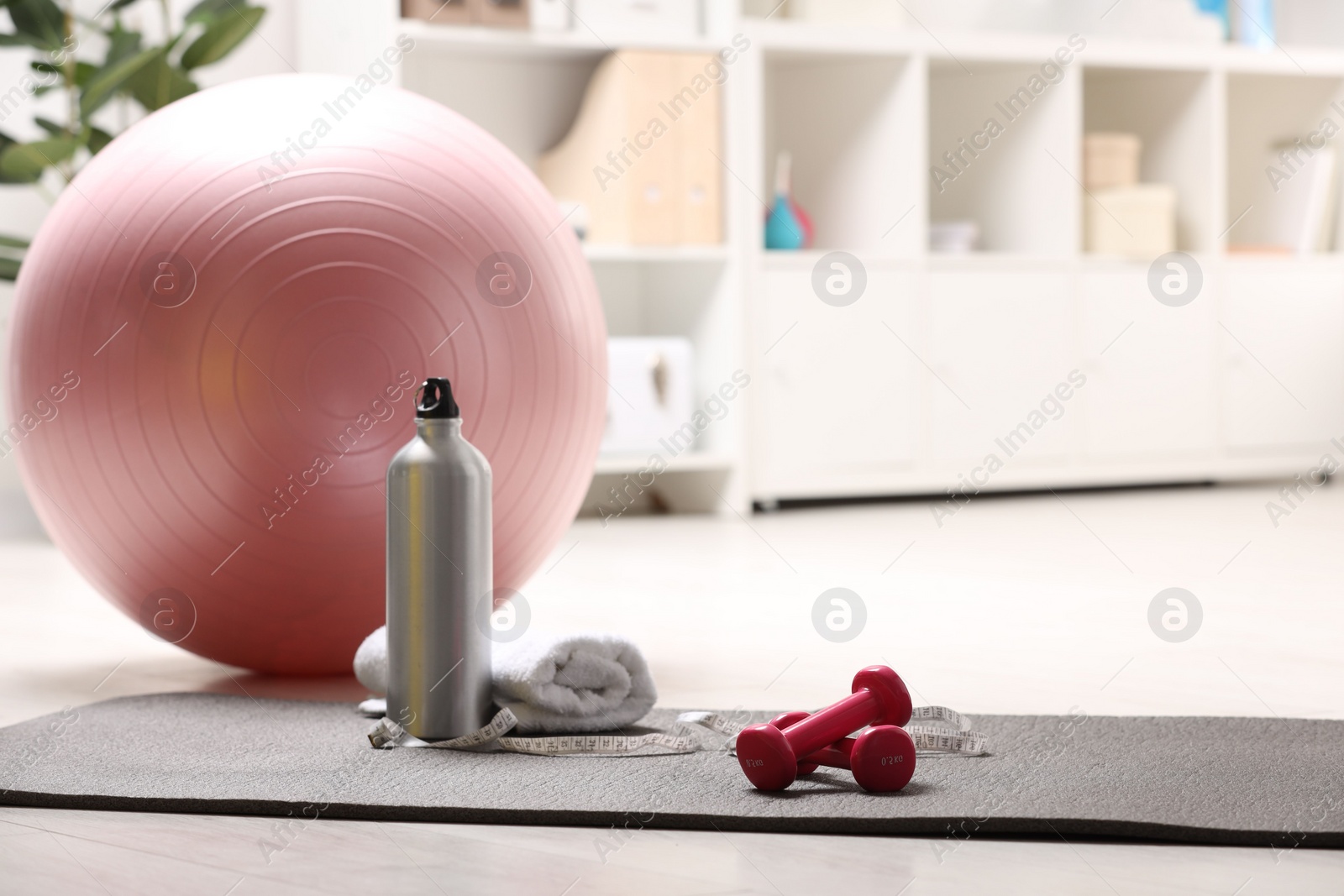 Photo of Many different sports equipment on floor indoors, space for text