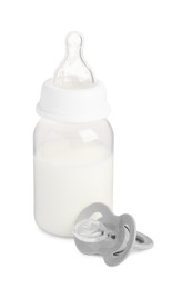 One feeding bottle with infant formula and pacifier on white background