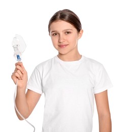 Photo of Cute girl holding nebulizer for inhalation on white background