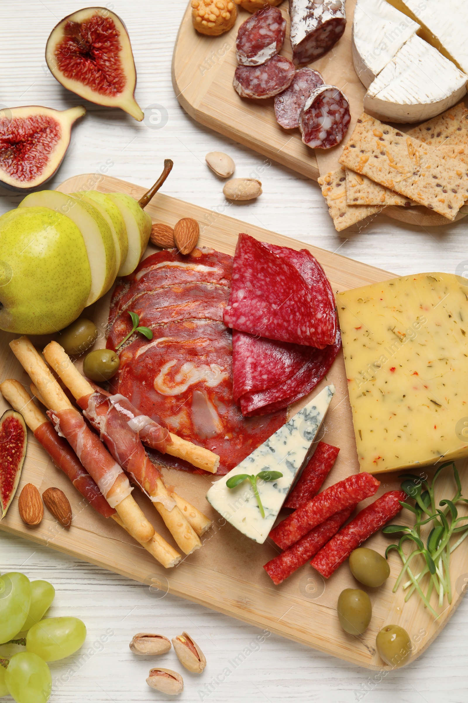 Photo of Set of different delicious appetizers served on white wooden table, flat lay