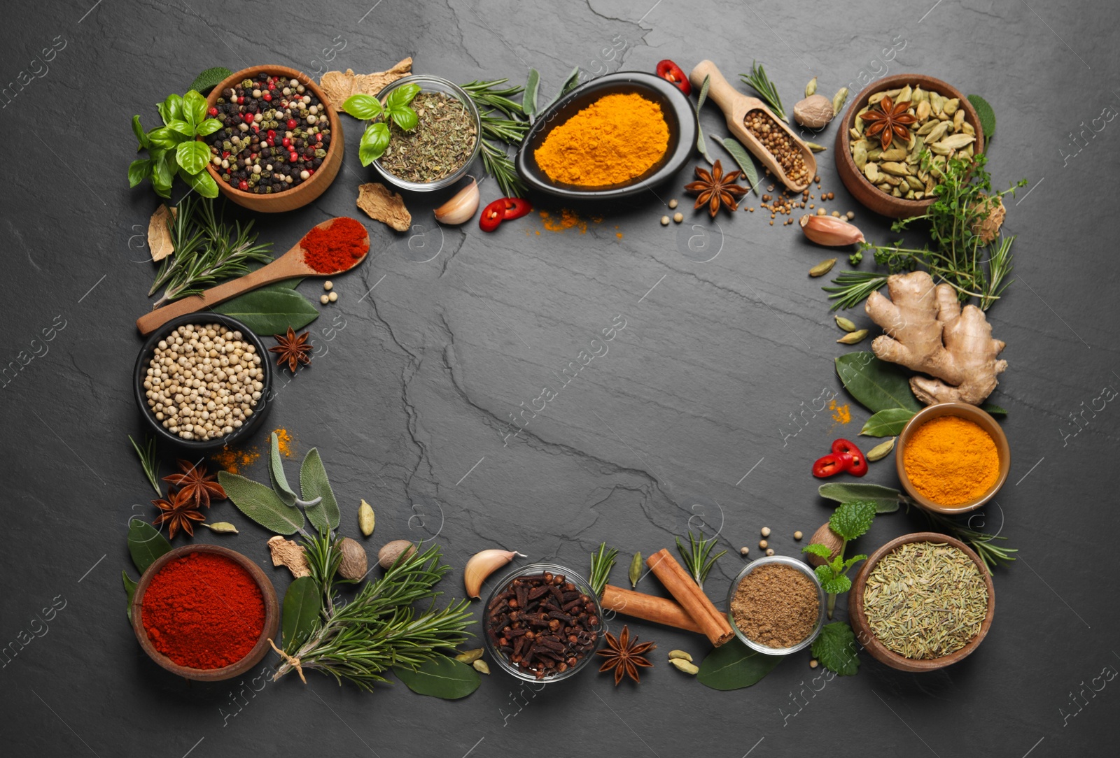 Photo of Frame of different herbs and spices on black table, flat lay. Space for text