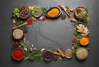 Photo of Frame of different herbs and spices on black table, flat lay. Space for text