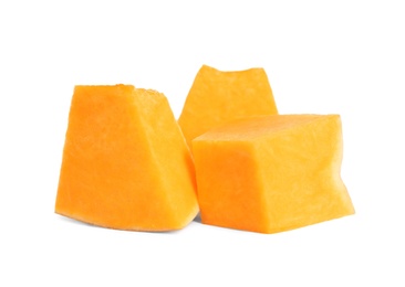 Pieces of ripe orange pumpkin on white background