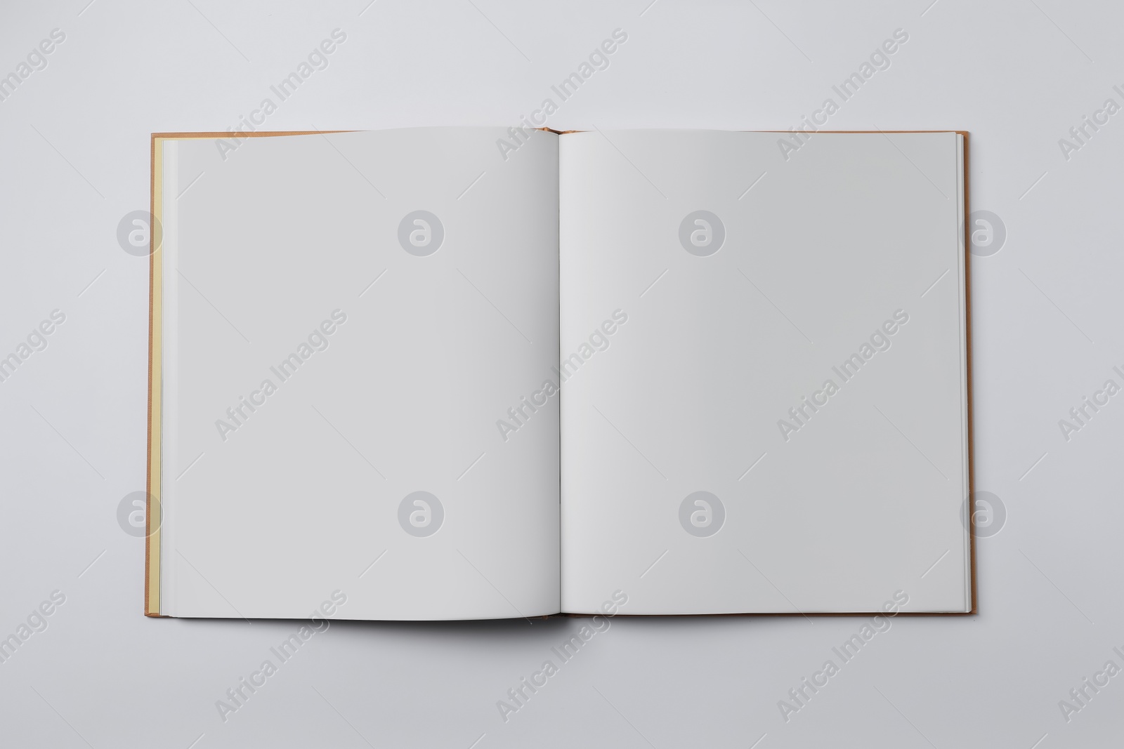 Photo of Open book on white background, top view