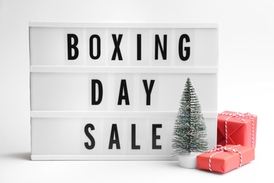 Photo of Lightbox with phrase BOXING DAY SALE and Christmas decorations on white background