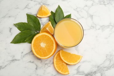 Photo of Delicious orange juice and fresh fruit on white marble table, flat lay