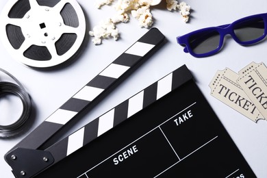Photo of Flat lay composition with clapperboard, film reel and 3D glasses on grey background
