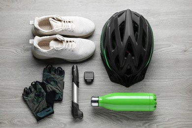 Flat lay composition with different cycling accessories on wooden background