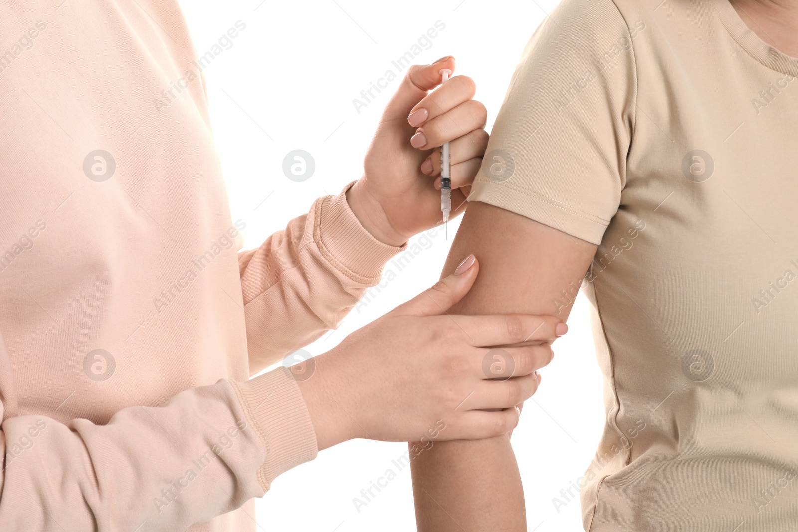 Photo of Diabetes. Woman getting insulin injection on white background, closeup