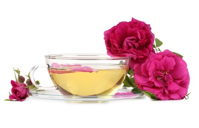 Photo of Aromatic herbal tea in glass cup and peonies isolated on white