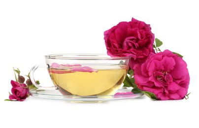 Aromatic herbal tea in glass cup and peonies isolated on white