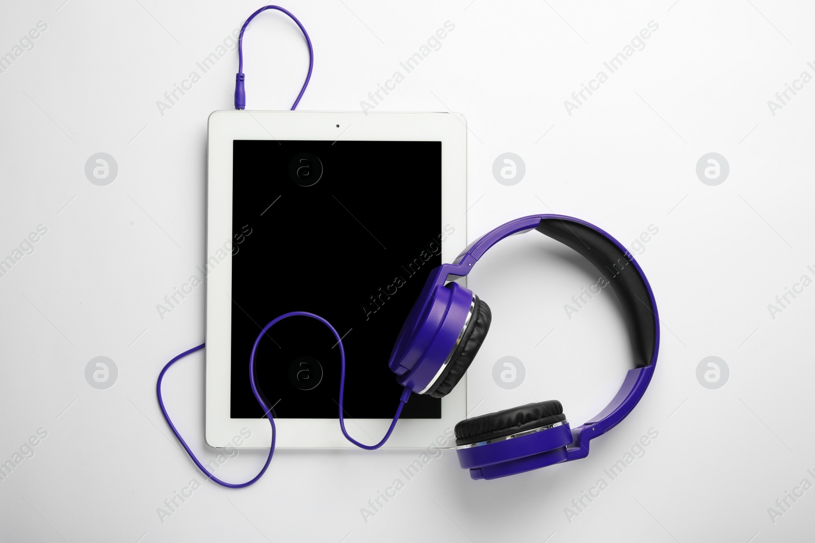 Photo of Stylish headphones and modern tablet on white background, top view