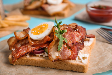 Delicious sandwich with bacon on table, closeup