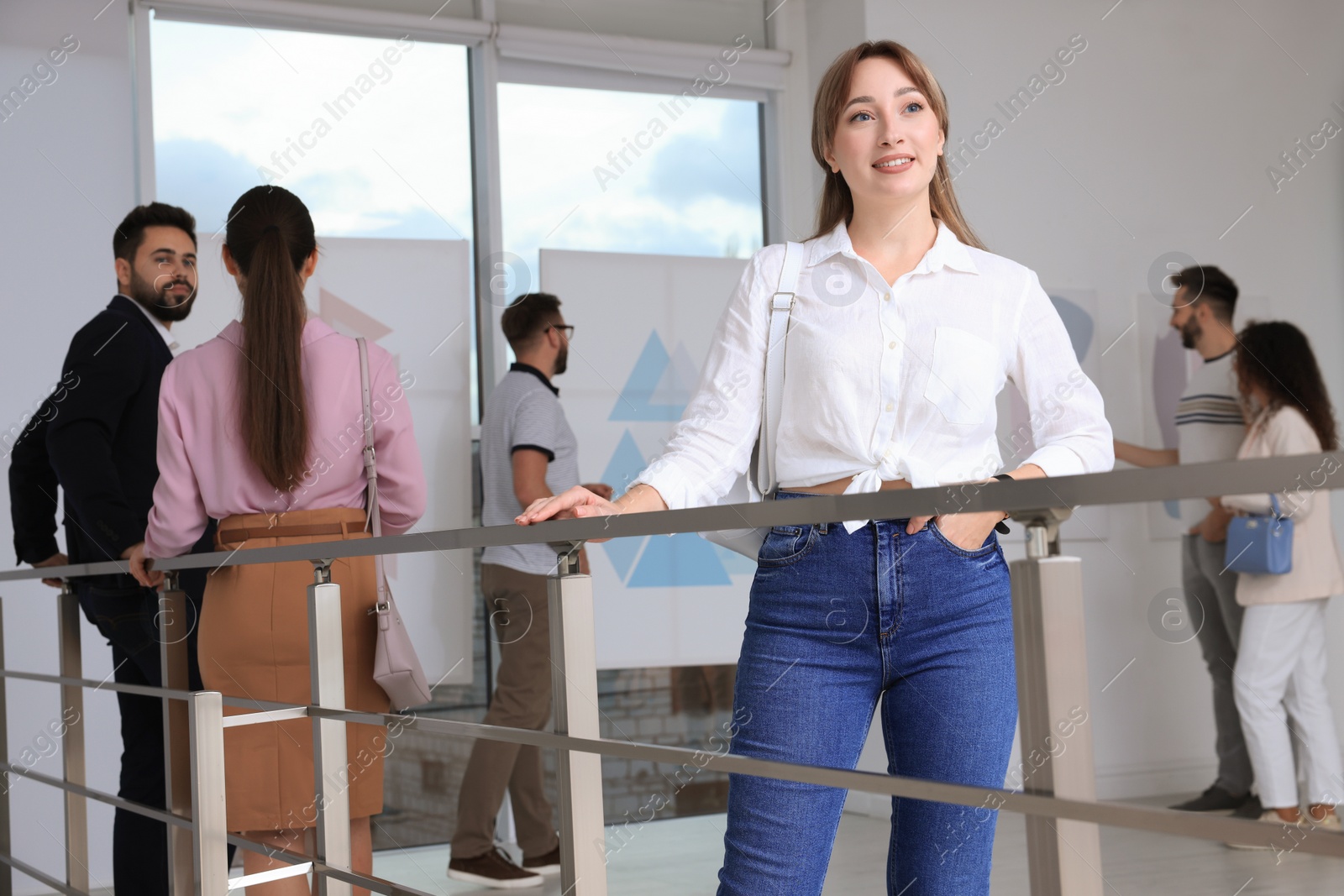 Photo of Happy young woman at exhibition in art gallery