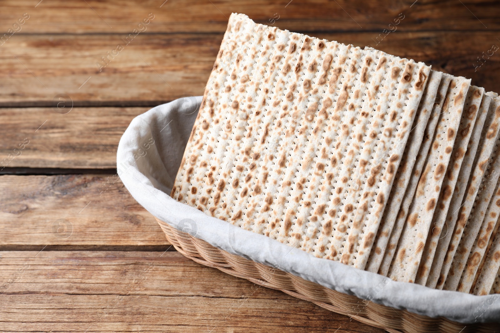 Photo of Traditional matzos in basket on wooden table