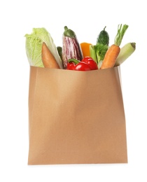 Photo of Paper bag with vegetables on white background