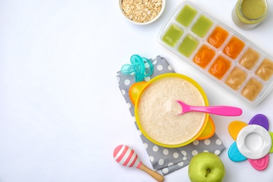 Photo of Flat lay composition with bowl of healthy baby food and space for text on white background