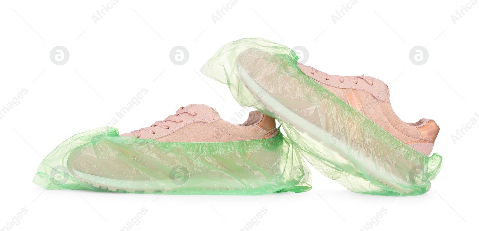 Photo of Sneakers in green shoe covers isolated on white